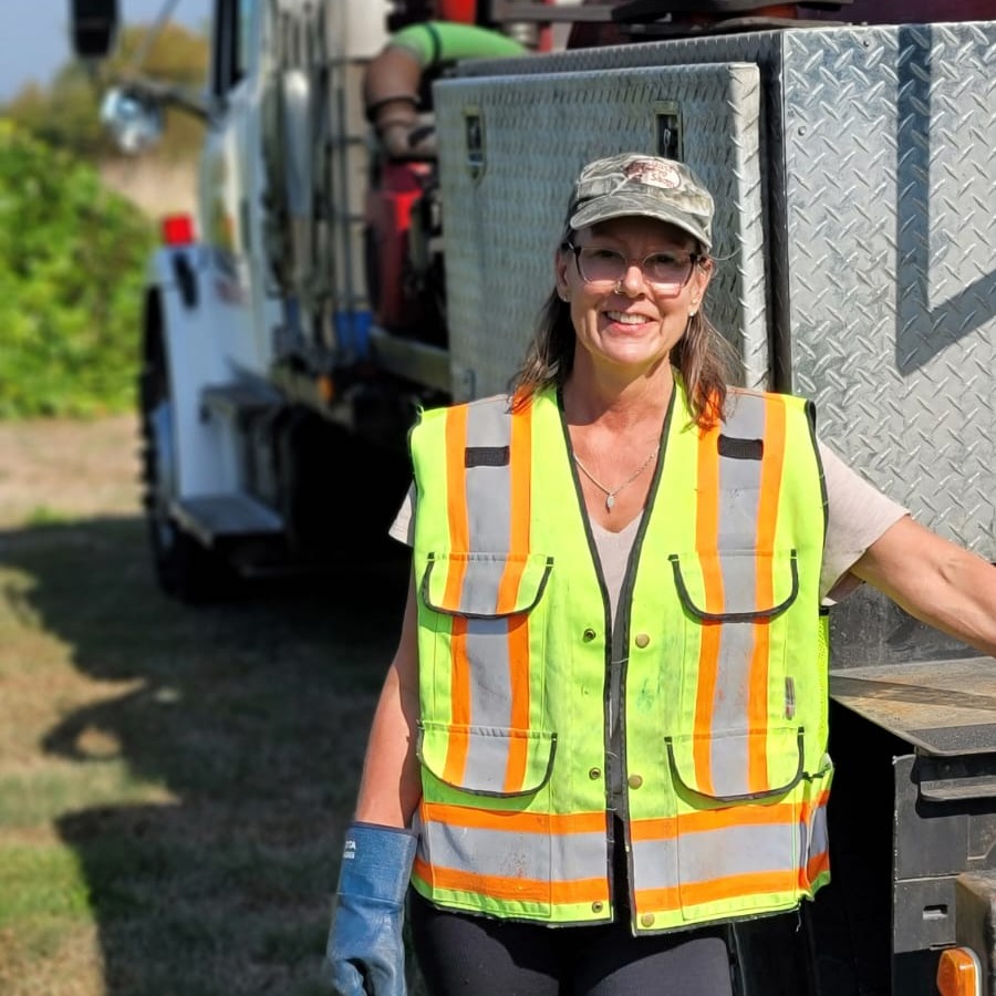 Clearset employee smiling by their vacuum truck