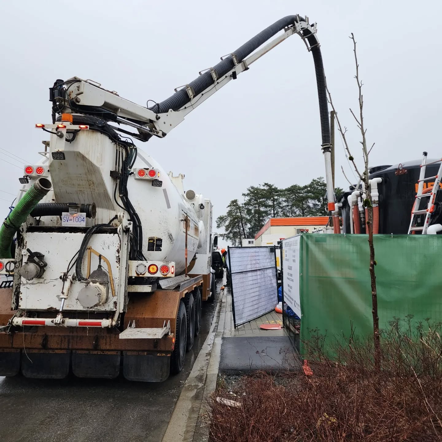 Clearset VAC truck removing sediment from a holding tank