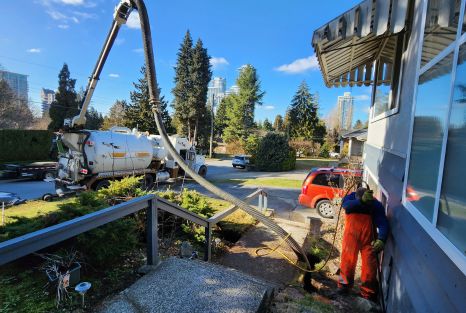 Clearset tri-drive hydrovac truck being used by employee for a hydrovac excavation