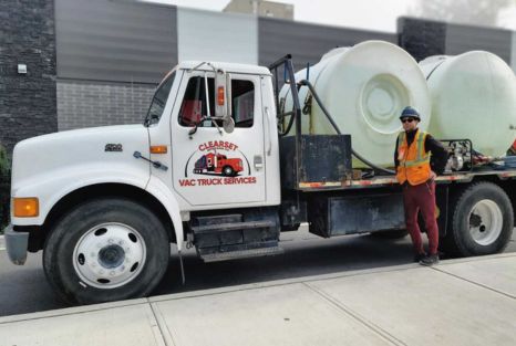 Employee standing in front of Clearset's non-potable water delivery truck.