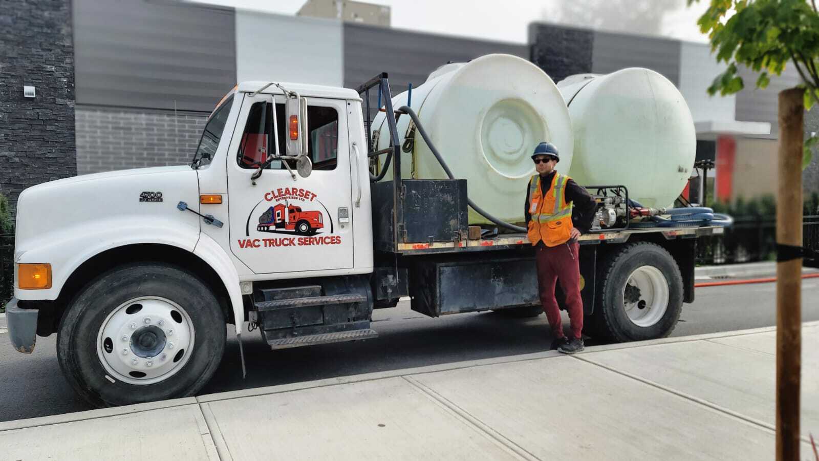 Employee standing in front of Clearset's non-potable water delivery truck.