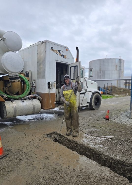 Clearset employee and truck performing a daylighting service in BC