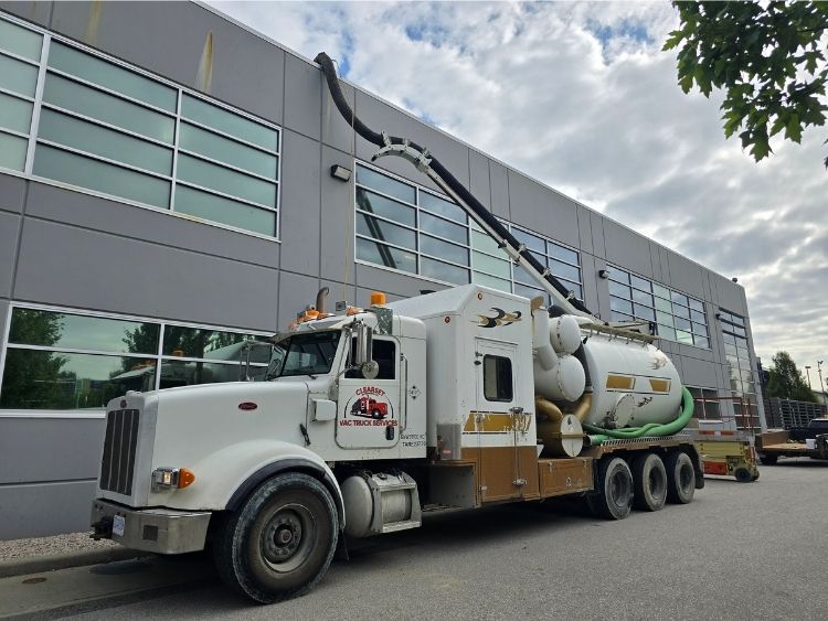 Clearset's hydrovac truck reaching up to a lower mainland building's roof